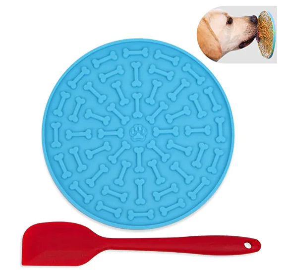 Blue silicone mat with bone pattern and red spatula on a white background