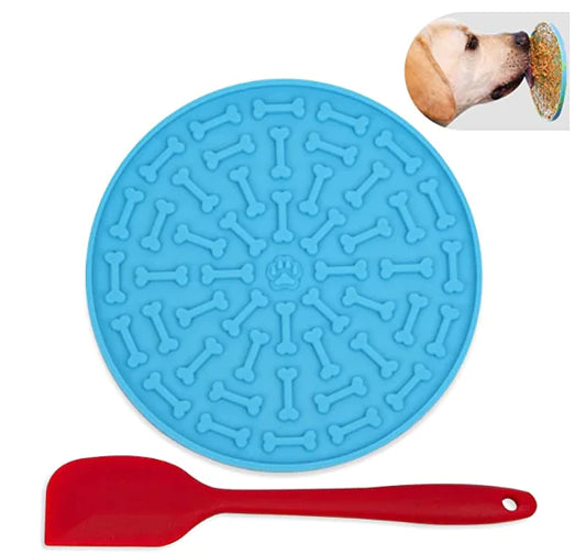 Blue silicone mat with bone pattern and red spatula on a white background